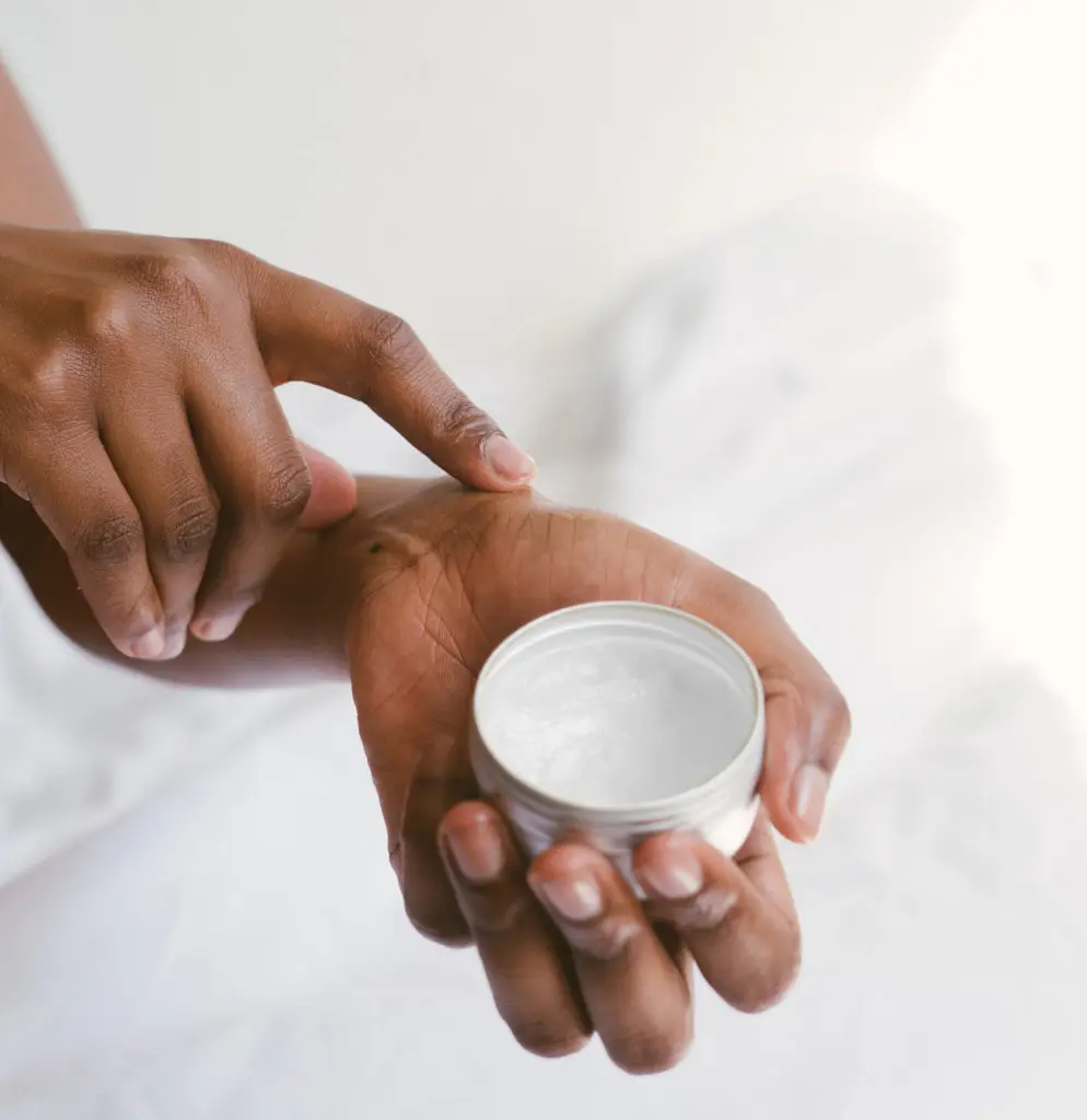 Person rubbing Porphyridium cruentum cream